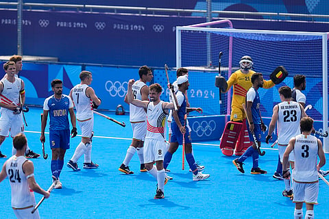 Belgium players celebrate after making a save from a penalty corner 